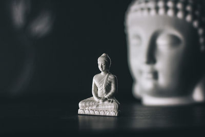 Close-up of buddha statue on table