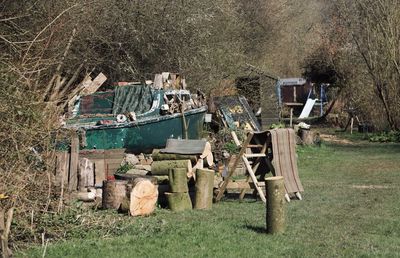 Stack of garbage on field by trees in forest