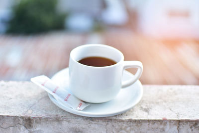 High angle view of coffee cup on retaining wall