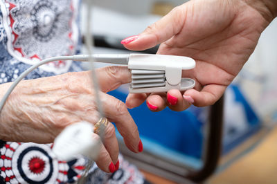 Cropped hand of person using mobile phone