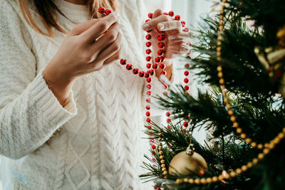 Midsection of woman holding christmas tree