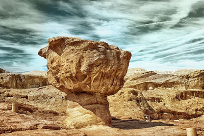 Rock formation on landscape against sky