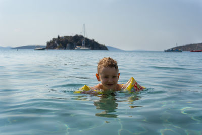 Portrait of boy swimming in sea