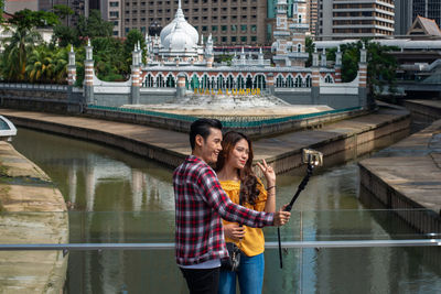 Young couple standing on a canal