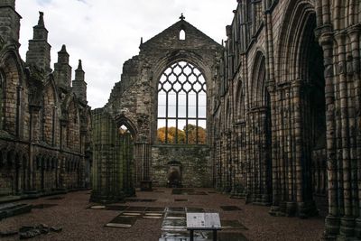 Old ruined holyrood palace against sky