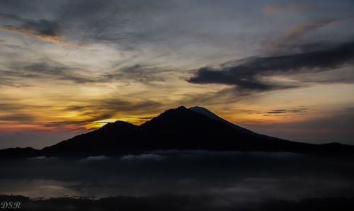 Scenic view of silhouette mountains against sky during sunset