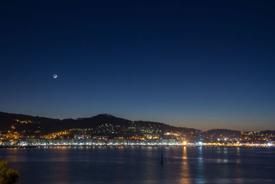 Scenic view of sea against clear sky at night