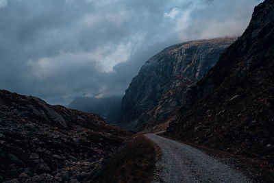 Road amidst rocks against sky
