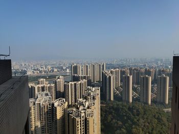 High angle view of buildings in city against clear sky