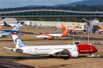 Airplane on airport runway against sky