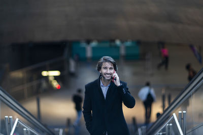 Portrait of young man standing in city