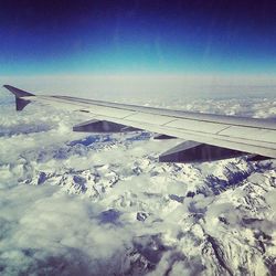 Cropped image of airplane on snow covered landscape