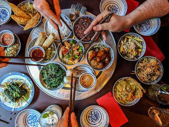 High angle view of people eating asian food