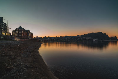 Bridge over river against sky during sunset