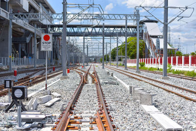 Railroad tracks in city against sky