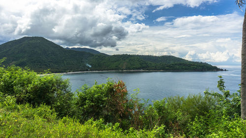 Scenic view of lake and mountains against sky