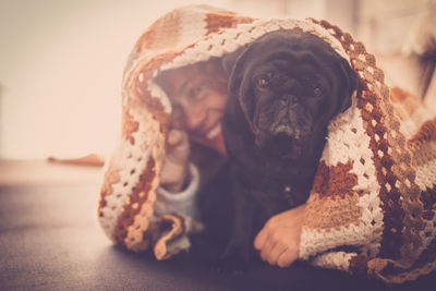 Smiling woman with dog at home