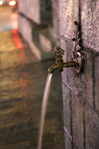 Close-up of faucet against wall