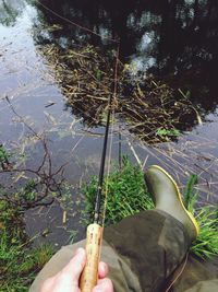 Low section of person standing in water