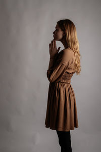 Woman standing against white background