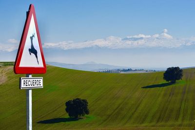 Information sign on landscape against sky