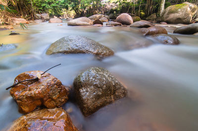 Close-up of pebbles in water