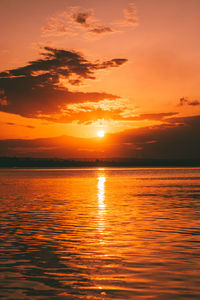 Scenic view of sea against orange sky