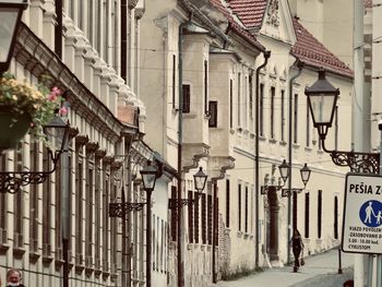 People walking on street amidst buildings in city