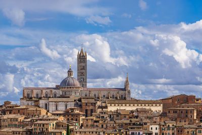 Buildings in city against sky