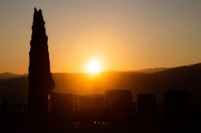 Silhouette mountains against sky during sunset