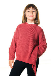 Portrait of young woman standing against white background