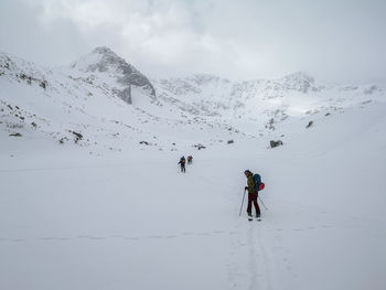 Woman skiing on snowcapped mountain