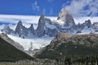 Scenic view of mountains against cloudy sky