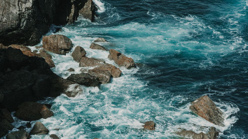 High angle view of rocks in sea