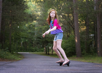 Pre teen red haired girl ripsticking