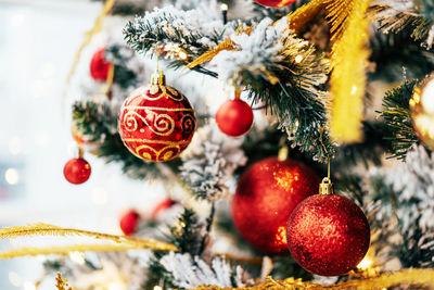 Close-up of christmas decorations hanging on tree