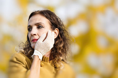 Portrait of young woman looking away outdoors