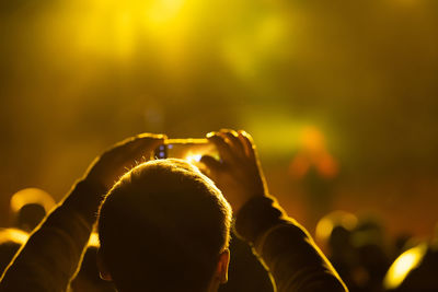 Rear view of people enjoying at music concert