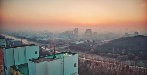 High angle view of buildings against sky during sunset