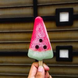 Close-up of hand holding ice cream cone