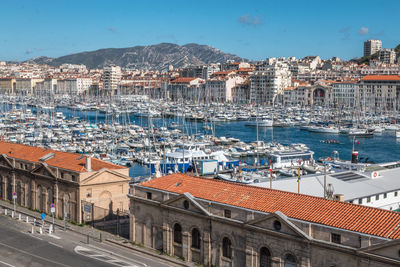 High angle view of harbor by buildings in city