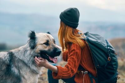 Rear view of woman with dog