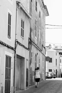 Rear view of person walking on street
