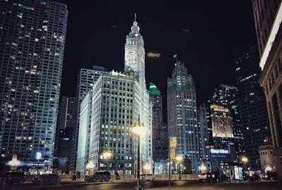 Chicago low angle view of skyscrapers lit up at night