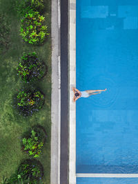 Aerial view of attractive woman floating over water at resort