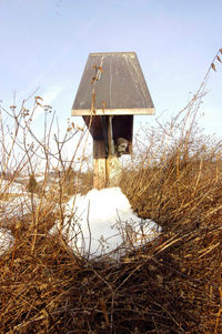 Gazebo on field against sky during winter