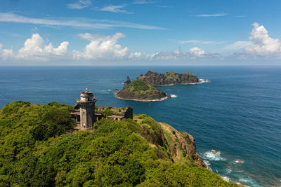 Lighthouse and tropical islands on the background of the blue ocean. cape engano. palaui island.  