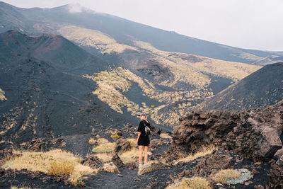 Rear view of man walking on mountain