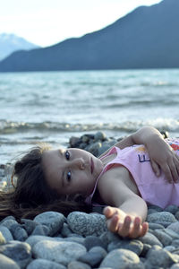 Portrait of boy lying on beach