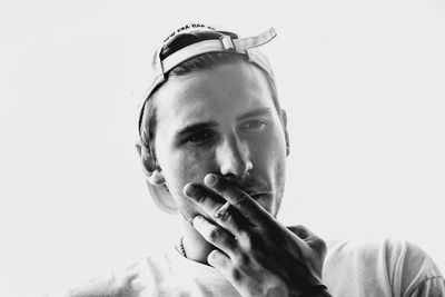 Portrait of young man against white background